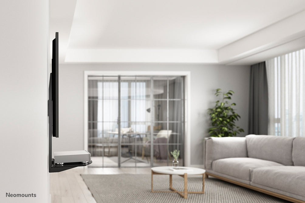 Supporto AV Neomounts, modello NS-SHELF100, è ideale per posizionare apparecchiature AV sotto supporti per flat screen.