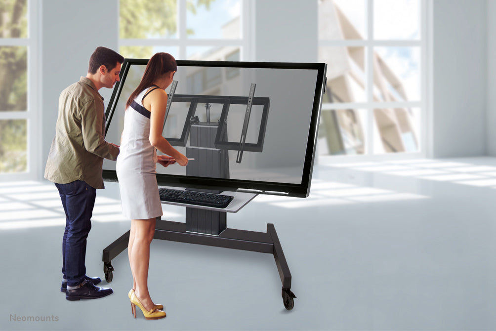 Neomounts PLASMA-M2500T nero è un carrello elettrico regolabile in altezza con funzione di inclinazione a 90 gradi per flat screen fino a 100 pollici.
